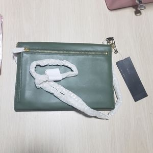 Style with Bcbgmaxazria green leather clutch. 💚✨ #Bcbgmaxazria #ChicAccessory